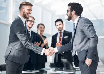 handshake of business people in a modern office