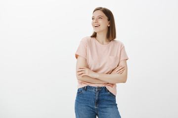 Indoor shot of self-assured arrogant fashionable girlfriend in t-shirt, holding hands crossed on...