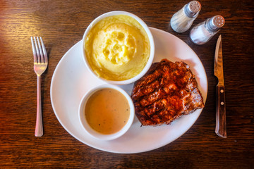 Lunch with rib eye steak with black pepper and salt in sight.