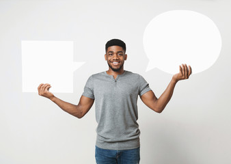 African-american man holding blank speech bubble on white