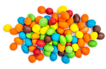 Pile of sweet round colorful candies on white. Top view.