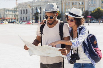 Loving couple planning walk route with map