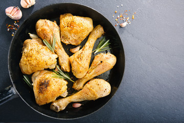 Tasty baked chicken legs with spices on pan