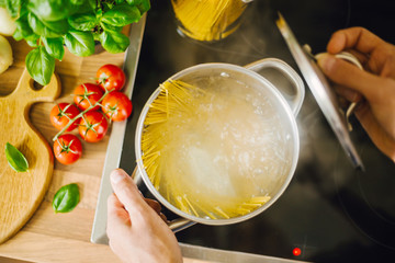Man cooking pasta in boiling water