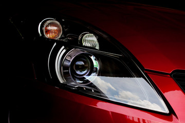 Car headlights of red color dark tone is aggressive and gorgeous.