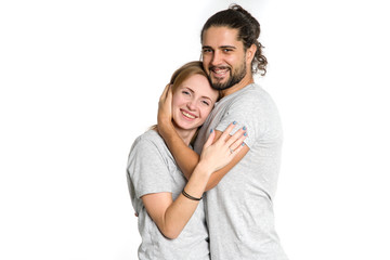 Portrait of happy couple on white background. Couple man and woman hugging and looking at camera.