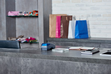 Digital devices, payment terminal and paper bags in shop