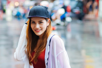 Travelers wore casual red t-shirts, black shorts, and white robes, in Bangkok's Chinatown.