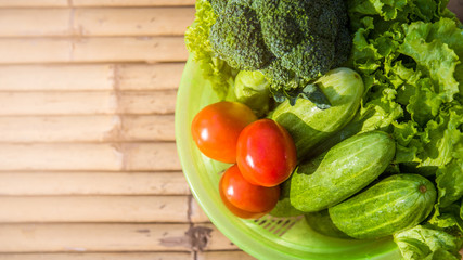 Healthy Food. There are vegetables, cucumbers, tomatoes and broccoli in the sieve for cleaning.