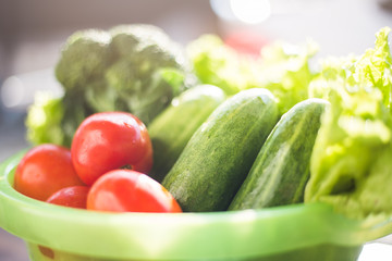 Healthy Food. There are vegetables, cucumbers, tomatoes and broccoli in the sieve for cleaning.