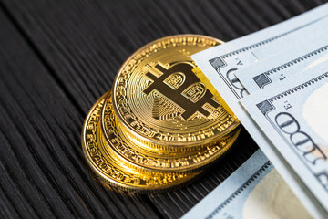 golden bitcoin coin on us dollars