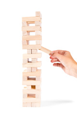 The tower from wooden blocks and woman hand take one block