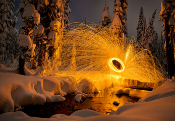 Steel Wool spinning and showering the snow with orange glow