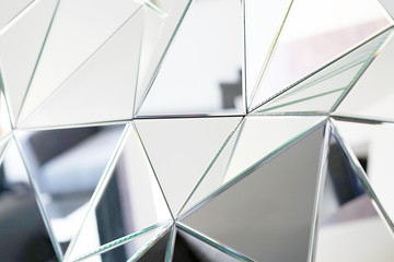 Mirror with crystals in wall, decoration and reflection. Abstract glass background. Polygonal surface. Close-up. Texture. - obrazy, fototapety, plakaty