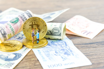 Businessman Shake hands on bitcoins and Banknotes dollars, money, won, yen. the form of digital (Cryptocurrency) an intermediary in the exchange of goods and services. Image use for business concept.