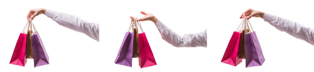 Hand holding shopping bags with christmas shopping on white back