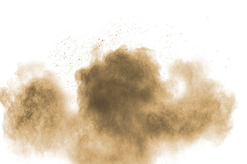 Brown particles splattered on white background. Brown dust splashing.