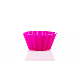 Pink silicone cupcake form on white background