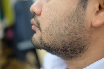 Obraz premium Close-up of a young man with beard and mustache