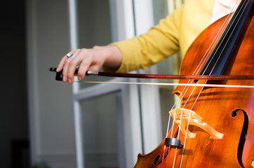 Female classical musician playing cello