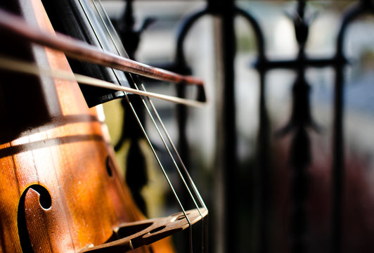 Playing cello on a balcony. Close-up