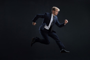 Fototapeta na wymiar Fast business. Running businessman in business suits, concept