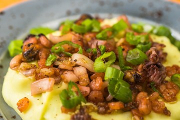 Small pieces of seafood mix with mashed potato, closeup.