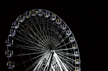 Ferris wheel at night on black background