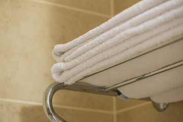 white terry towel on the shelf in the hotel bathroom