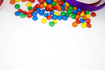 colorful chocolate buttons on a white background