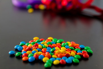 colorful chocolate buttons on a black background