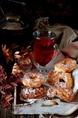 Tasty donuts on wooden tray with gllas tea