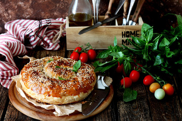 Flaky pastry filled with chicken meat and onions with cherry tomatoes and basil