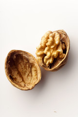 Raw walnuts with cracked nutshells on white background isolated with copy space