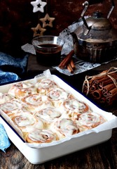 Cinnabon and dark coffee on the background 