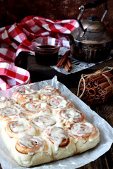 Cinnabon and dark coffee on the background 