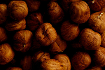 Macro shot of raw hazelhuts in a wooden bowl. Horizontal composition