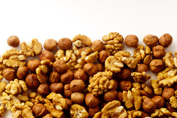 Overhead image of assorted nuts on white background with copy space