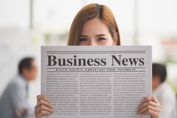 Business young woman presenting Business News closed her face hold on her hand and black ground is employees in meeting room,