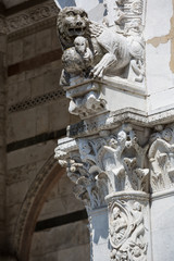 Lion sculpture and details from the beautiful duomo di San Martino in Lucca, Tuscany