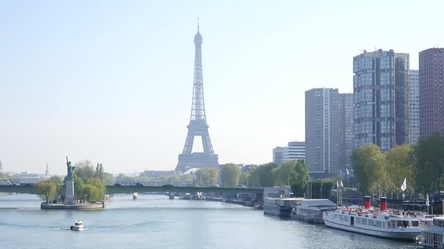 Statue of Liberty Seine river morning traffic and Eiffel Tower in Paris