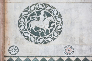 Mosaic details set in the wall at the beautiful duomo di San Martino in Lucca, Tuscany