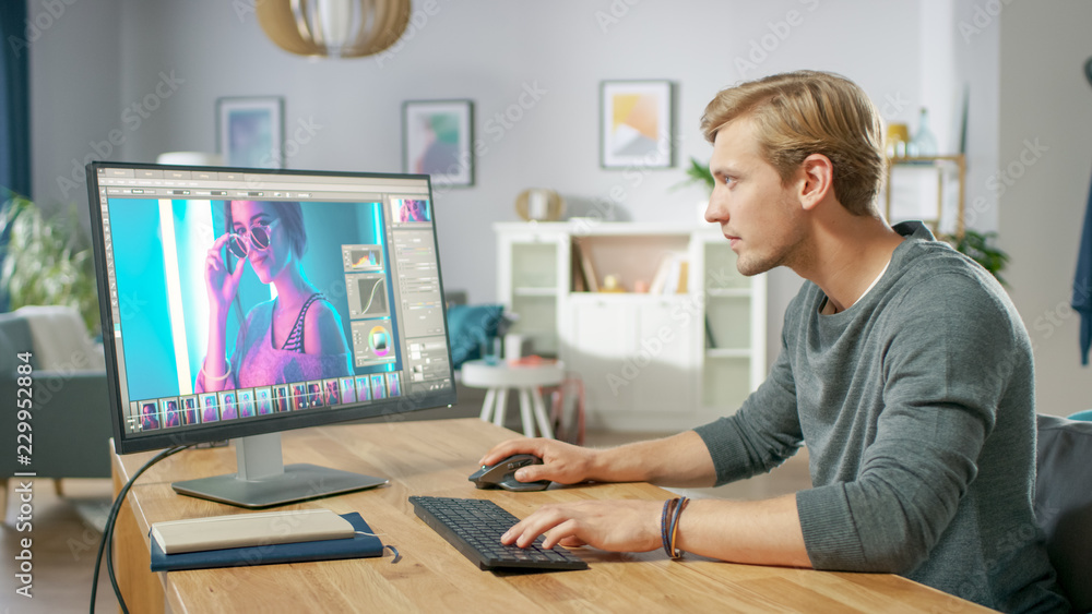 Poster professional photographer works in photo editing app / software on his personal computer. photo edit