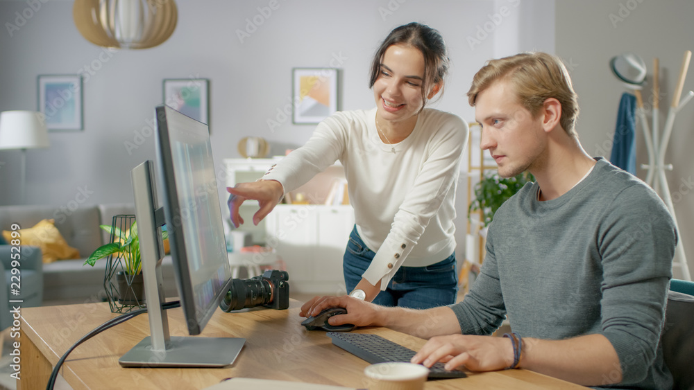 Poster male and female professional editors talk while working in photo editing app / software on a persona