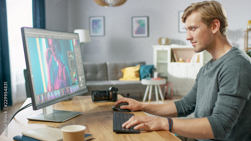 Poster professional photographer works in photo editing app / software on his personal computer. photo edit