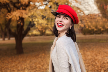 Beautiful cute smiling woman in autumn park