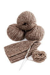 Balls of yarn and knitted handicrafts isolated on white background