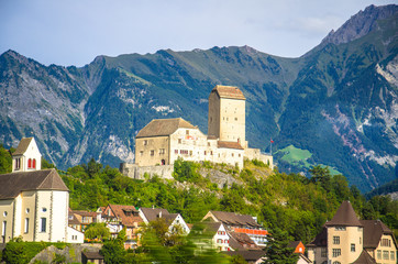 Old castle in front of mountains Alps near Vaduz town, Liechtenstein - obrazy, fototapety, plakaty