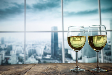 Two glasses with wine on a wooden table in an autumn setting   