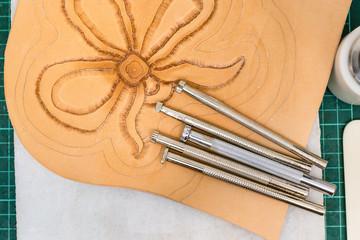 various Stamping tools on partly carved leather